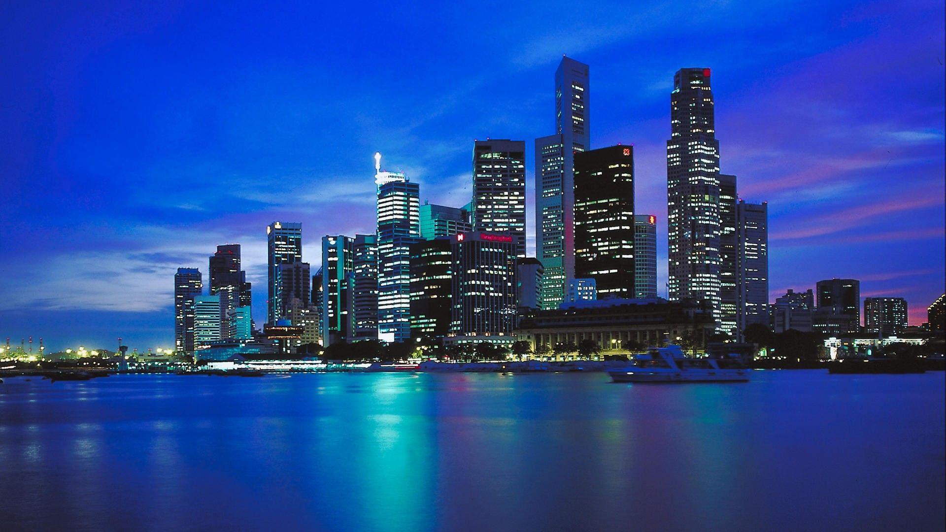 Modern cityscape at night, representing global finance